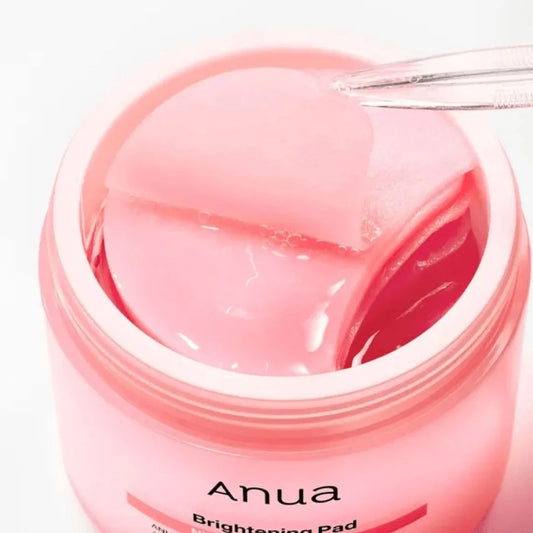 Anua Brightening Pad – pink skincare toner pads in jar with tweezers, for glowing skin routine