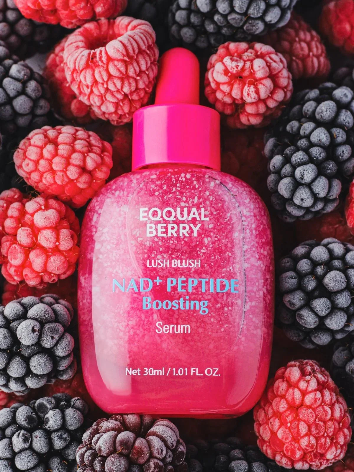 EQQUAL BERRY NAD+ Peptide Boosting Serum in pink bottle with raspberries and blackberries